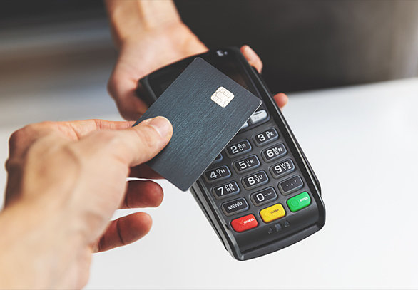 person using a card with a chip on payment machine